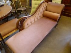 A Victorian Chaise Longue, with swept back supported on turned feet with pink upholstery.