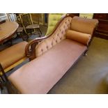 A Victorian Chaise Longue, with swept back supported on turned feet with pink upholstery.