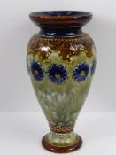 A Doulton Lambeth Ware Vase, cobalt floral highlights on green glaze, approx 18 cms high.