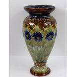 A Doulton Lambeth Ware Vase, cobalt floral highlights on green glaze, approx 18 cms high.