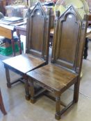 Two Oak Hall Chairs in the Gothic Style, turned legs on straight stretchers with decorative