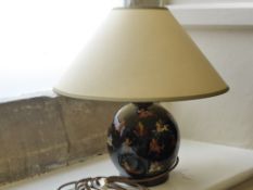 An Oriental Black Lacquer Hand Painted Table Lamp, depicting a hunting scene, approx 23 cms high