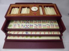 A Vintage Mahjong Set, together with an antique Japanese wooden box depicting chrysanthemums.