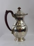 A Silver Hot Water Pot, Birmingham hallmark, dated 1937, having shell motif to spout, mm Adie