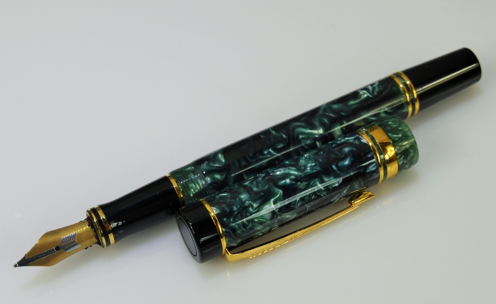 A Vintage Parker Ink Pen. The green marbled pen having an 18k gold nib with original box and