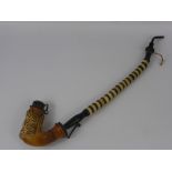 An Antique German Long Stem Pipe, the bowl with decorative carving depicting a stag, approx 49 cms.