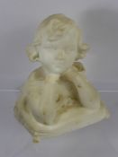 A White Marble Bust, depicting a small girl with elbows resting on a pillow, approx 21 cms