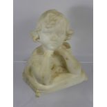 A White Marble Bust, depicting a small girl with elbows resting on a pillow, approx 21 cms