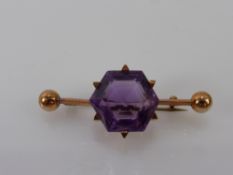A Lady's 9ct Rose Gold and Amethyst Brooch. Amethyst 14.5 mm, approx 6.4 gms.