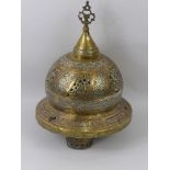 A Brass, Copper and White Metal Lamp, the lamp with Islamic motiff approx 22 cms high.