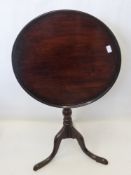 An Antique Mahogany Tilt Top Wine Table. The table on turned column with tripod base, approx 60 x 72