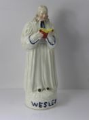 A Victorian Staffordshire Figure, Reverend John Wesley modelled preaching, on a circular base,