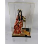 A Circa 1950's Japanese Doll, depicted wearing a Kimono with accessories, approx 40 cms. housed in a
