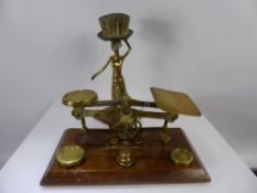 A Pair of English Brass Postal Scales, with weights together with a brass candle holder in the