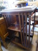 An Edwardian Revolving Book Case, with decorative inlay to the top, approx 51 x 92 cms.