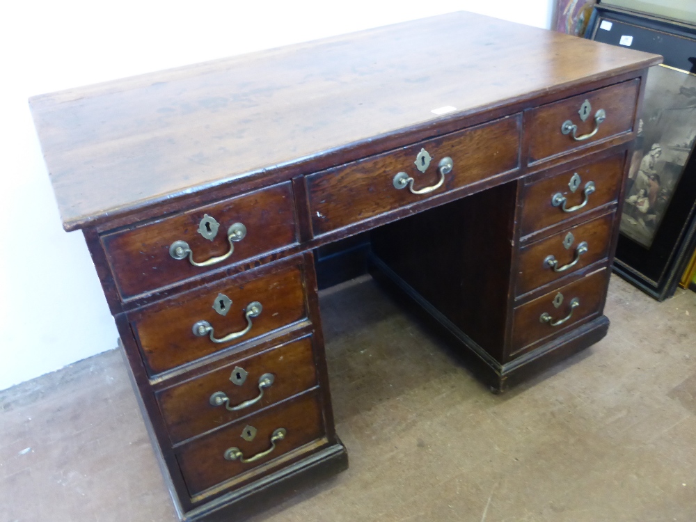 An Antique Oak Country Style Desk, having central drawer with four short drawers to either side,