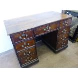 An Antique Oak Country Style Desk, having central drawer with four short drawers to either side,