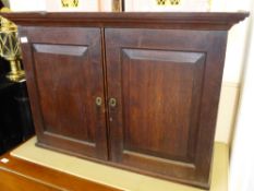 An Antique Oak Wall Cabinet, the cabinet having panelled doors and single shelf, approx 39 x 95 x 67