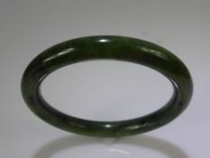 A Spinach Green Jade / Hardstone Bracelet, approx wt 41 gms, approx dia 7.5 cms.