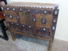 A Decorative Indian Chest, with three faux drawers and a central cupboard, the carved front