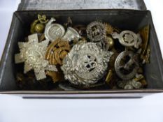 A Tin Containing a Collection of Military Badges etc., approx 100 items.