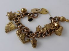 A Solid Gold 9 ct Rose Gold Charm Bracelet, with 10 9-ct yellow gold charms, including heart shape