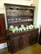 An Antique Stained Oak Dresser, three short drawers with three cupboards beneath, two plate racks,