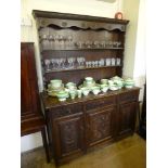An Antique Stained Oak Dresser, three short drawers with three cupboards beneath, two plate racks,