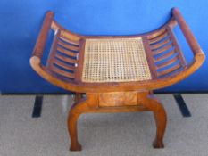 A Fruit Wood Window Seat, rattan seat, decorative carving to the frame front-swept sides, approx