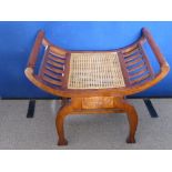 A Fruit Wood Window Seat, rattan seat, decorative carving to the frame front-swept sides, approx