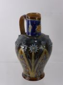A Doulton Lambeth Ware Ewer, the ewer with incised foliate motif and raised floral and beaded