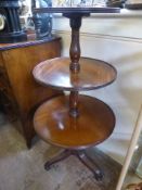 A George III Style Mahogany Dumb Waiter , the circular three tier waiter supported on turned central