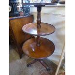 A George III Style Mahogany Dumb Waiter , the circular three tier waiter supported on turned central