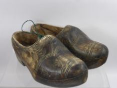 A Pair of Hand Carved Antique Dutch Clogs, together with a pair of wooden cobbler's shoe