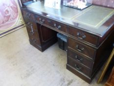 A Reproduction Mahogany Office Desk, the desk with green tooled leather insert, with four short