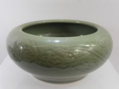An Antique Chinese Celadon Bowl. The bowl having cloud form decoration to side, approx 12 cms high x