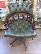 A Reproduction Green Leather Captain's Chair, on splayed legs and brass castors.