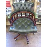 A Reproduction Green Leather Captain's Chair, on splayed legs and brass castors.