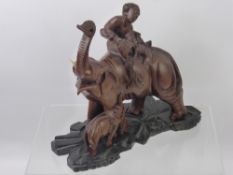 A Wood Carved Asian Elephant and Calf (af), on stand, approx 22 cms high.