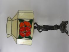 A Bedside Lamp, the base depicting a woman in the classical style, the shade of floral design,