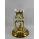 A Brass Twin Column Mantel Clock, with four weight pendulum, the clock having white enamel face with