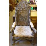 An Antique Oak Baronial Chair, the back rest with profuse decorative carving depicting a