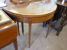 An Edwardian Folding Card Table, with burgundy baize and decorative inlay, on tapered legs (wf),