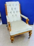 An Edwardian Arm Chair, on turned legs with original casters, upholstered in celadon velvet.