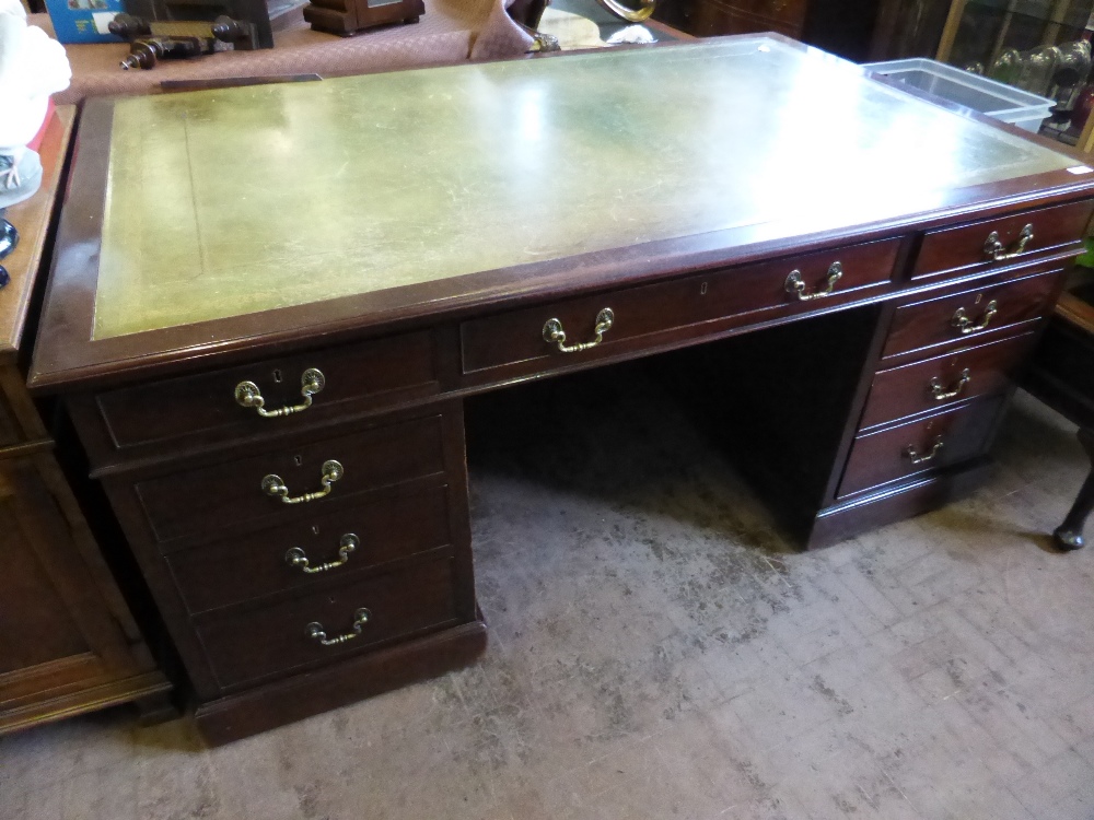 An Edwardian Mahogany Partner's Desk, four short drawers on the left, one central long drawer, two