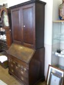 A Georgian Oak Drop Front Bureau/Book Case, the desk having two small drawers with two graduated