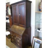 A Georgian Oak Drop Front Bureau/Book Case, the desk having two small drawers with two graduated