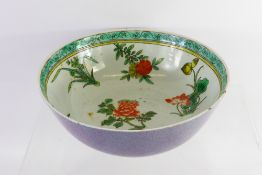 An Antique Chinese Famille Vert Bowl, hand painted with tree peonies, chrysanthemums and prunus,