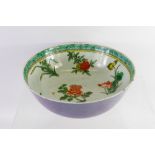 An Antique Chinese Famille Vert Bowl, hand painted with tree peonies, chrysanthemums and prunus,