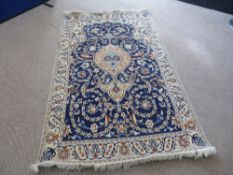 A Hand Knotted Persian Wool and Silk Nain Rug, approx 210 x 120 cms.